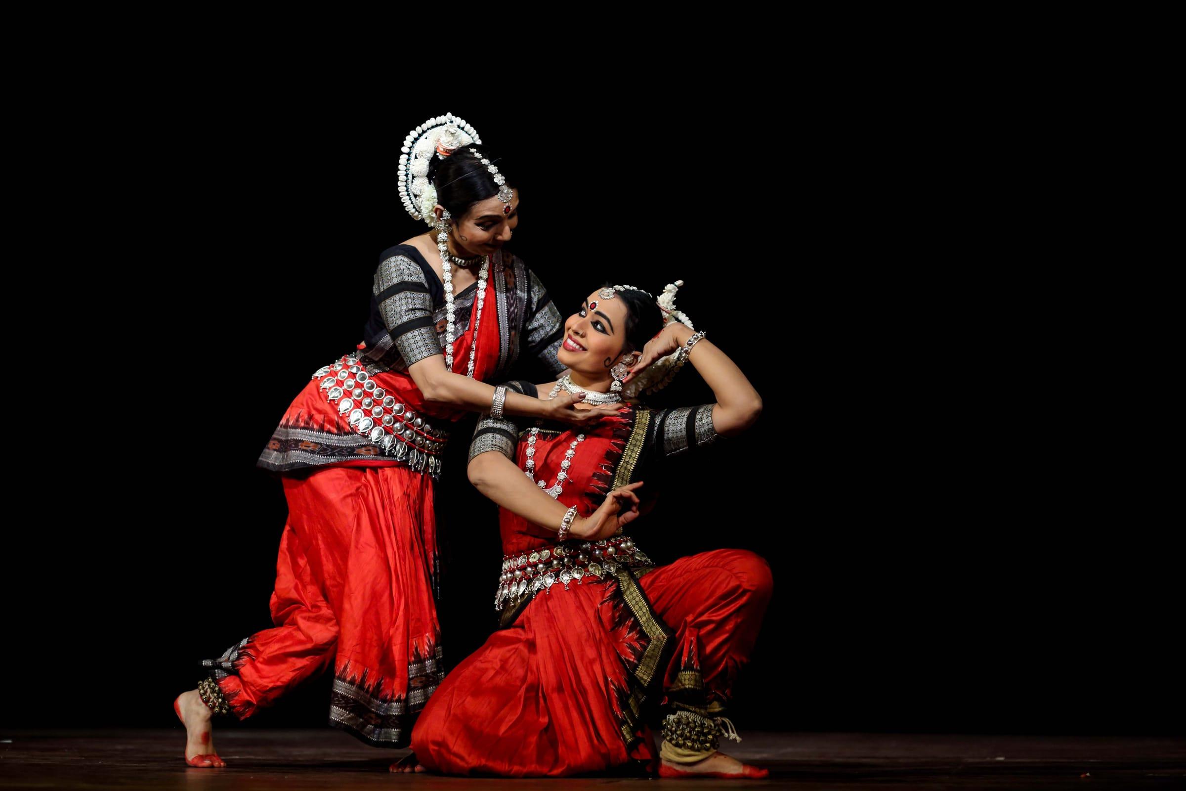 Two Bharatanatyam dancers perform on stage at an arangetram in the GTA