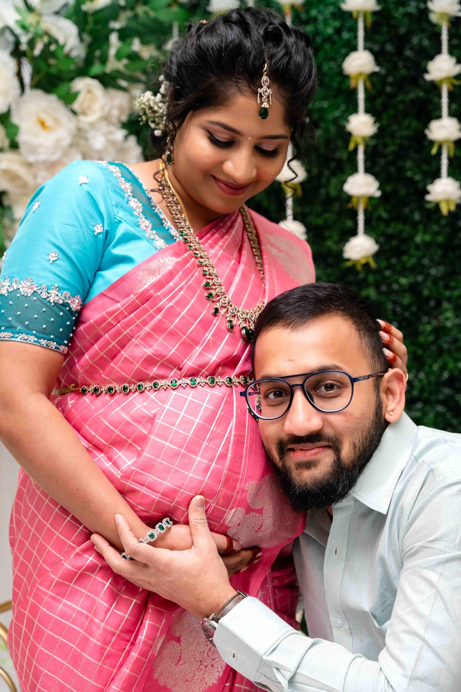 Mom-to-be in a pink saree with her partner at her seemantham