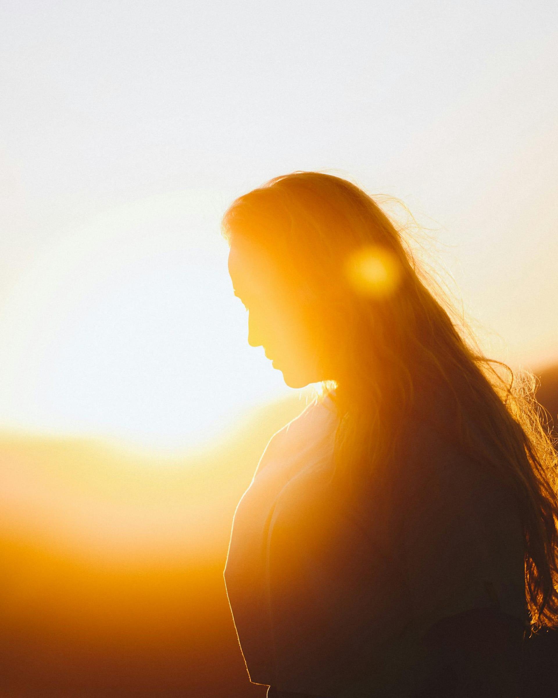 Woman backlit by a golden sunset, fall portrait session